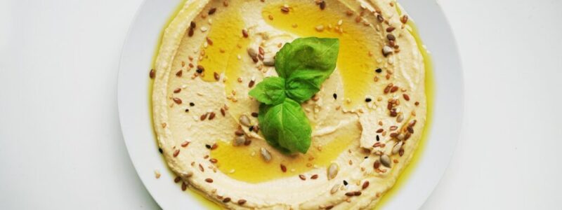 A serving of hummus in a plate.