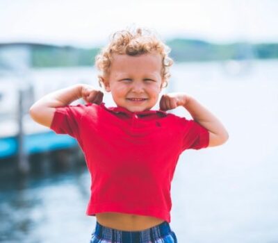 A healthy boy flexing his arms