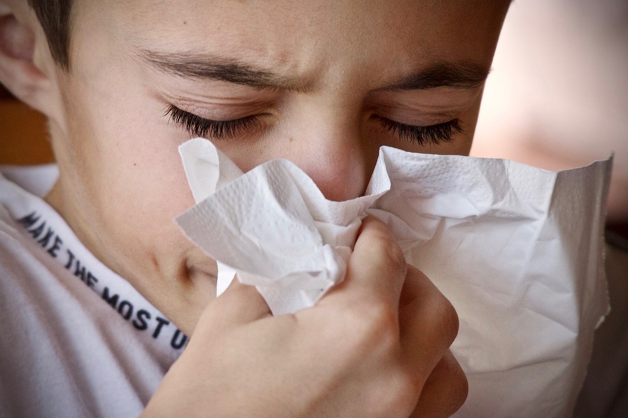 A child having colds and sneezing