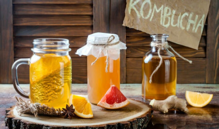 A small girl drinking kombucha.