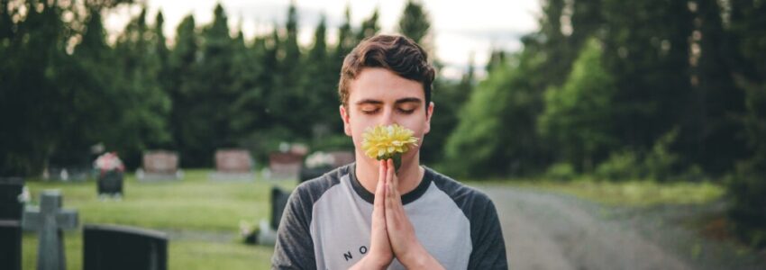 A man with healthy immune system smelling flowers