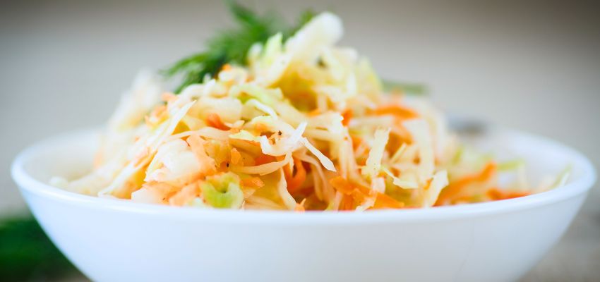 Fresh sauerkraut in a ceramic bowl representing health benefits sauerkraut offers