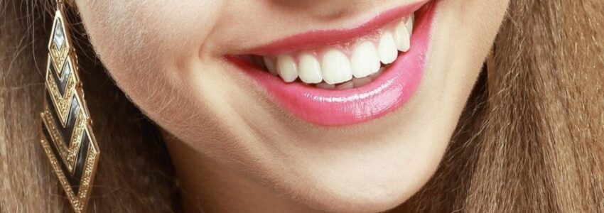 A woman\'s smile showing good oral health.