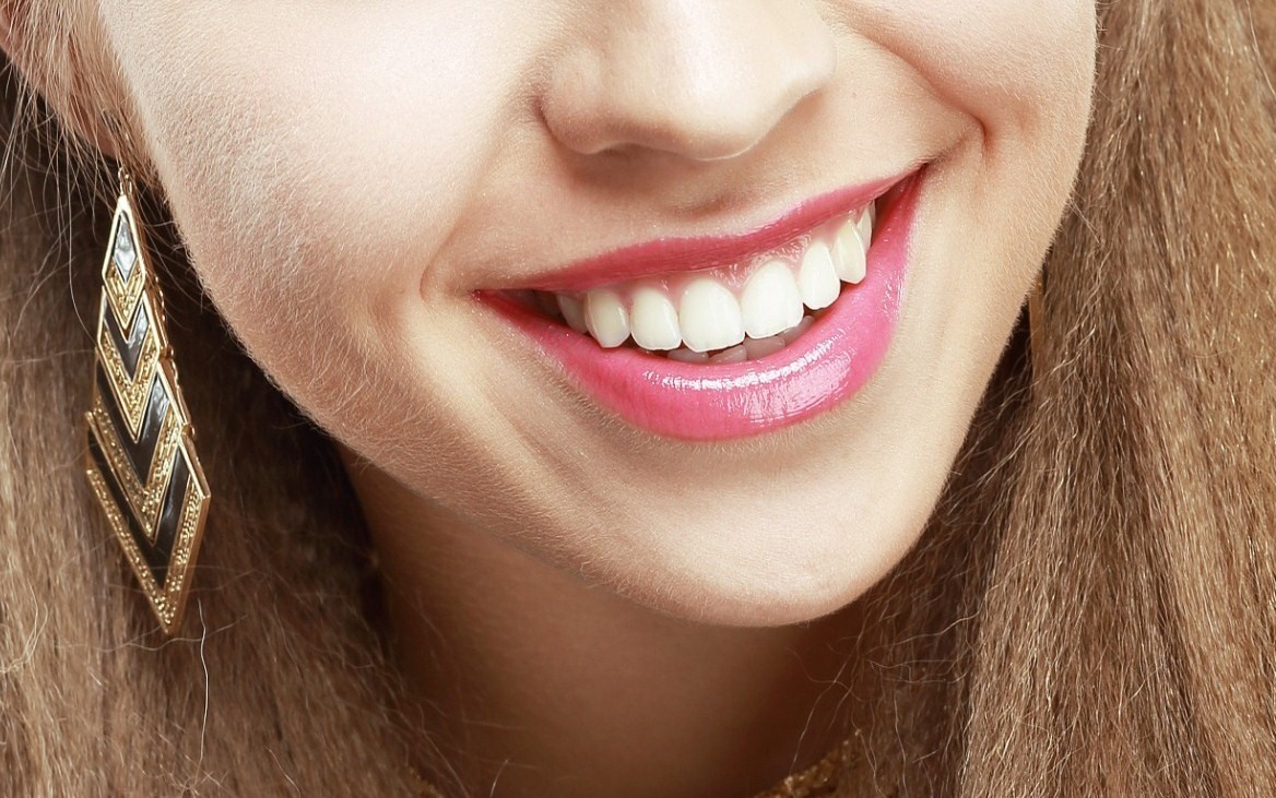 A woman's smile showing result of oral probiotics