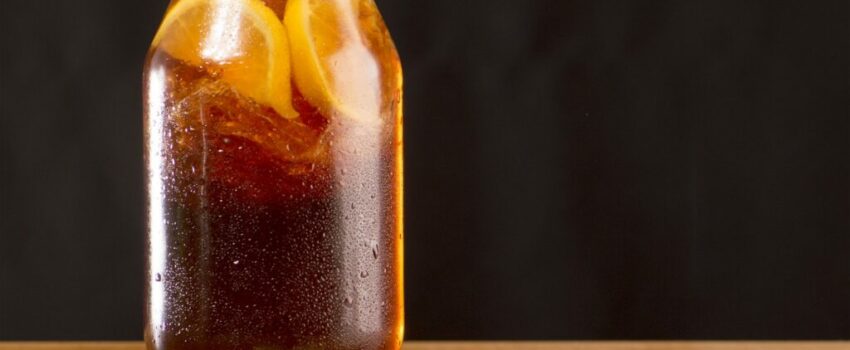 An ice-cold kombucha in a glass jar.