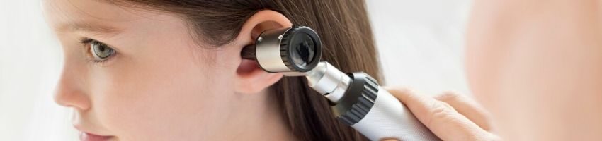 A child being inspected for glue ear