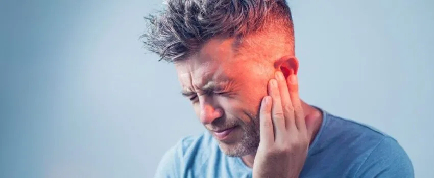 A man having ear pain because of glue ear