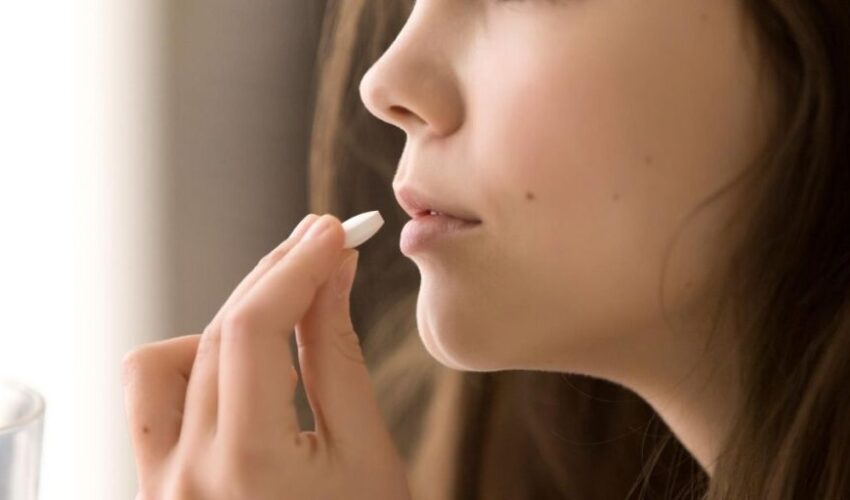 A woman smiling after her mouth sore was treated.