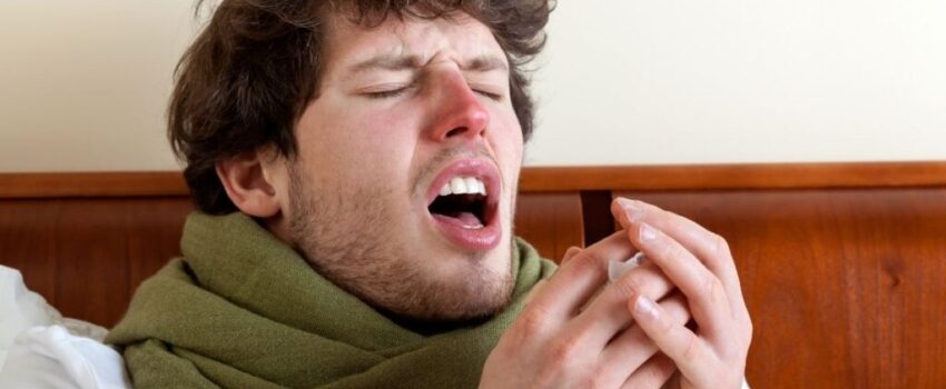 A woman smiling after her mouth sore was treated.