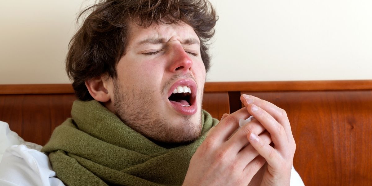 Man sneezing with Sinus Infection