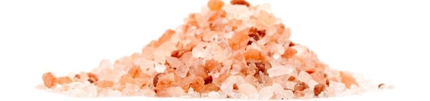 Heap of pink Himalayan salt isolated on white background