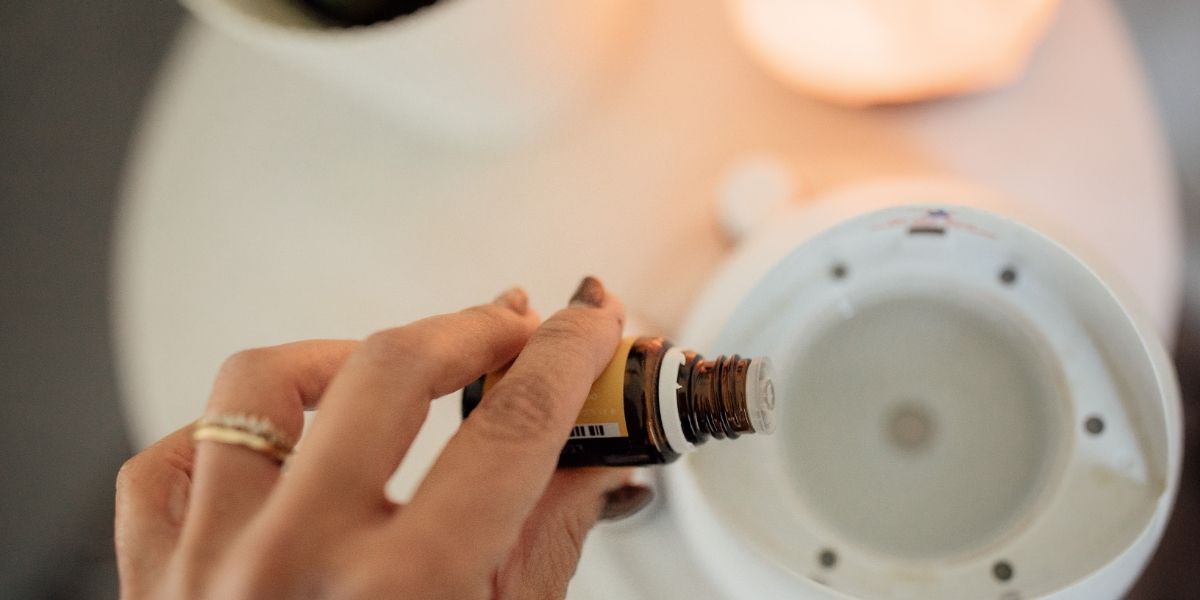 Woman hand putting himalayan salt inhaler oil in diffuser