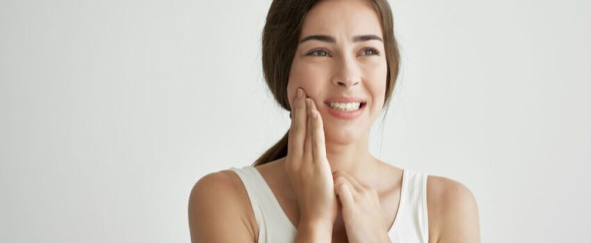 A woman smiling after her mouth sore was treated.