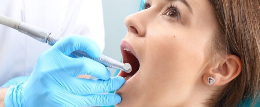 A woman smiling after her mouth sore was treated.