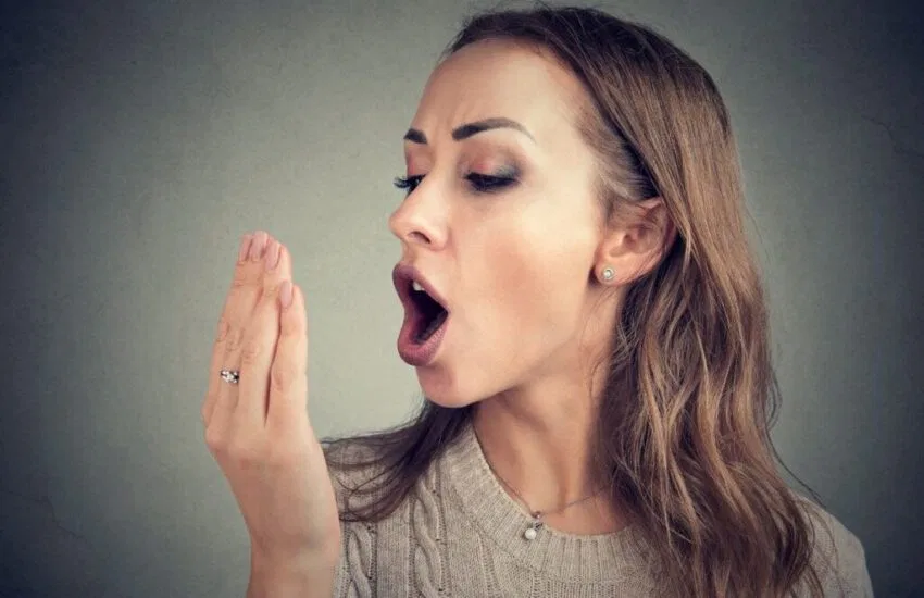 A woman smiling after her mouth sore was treated.