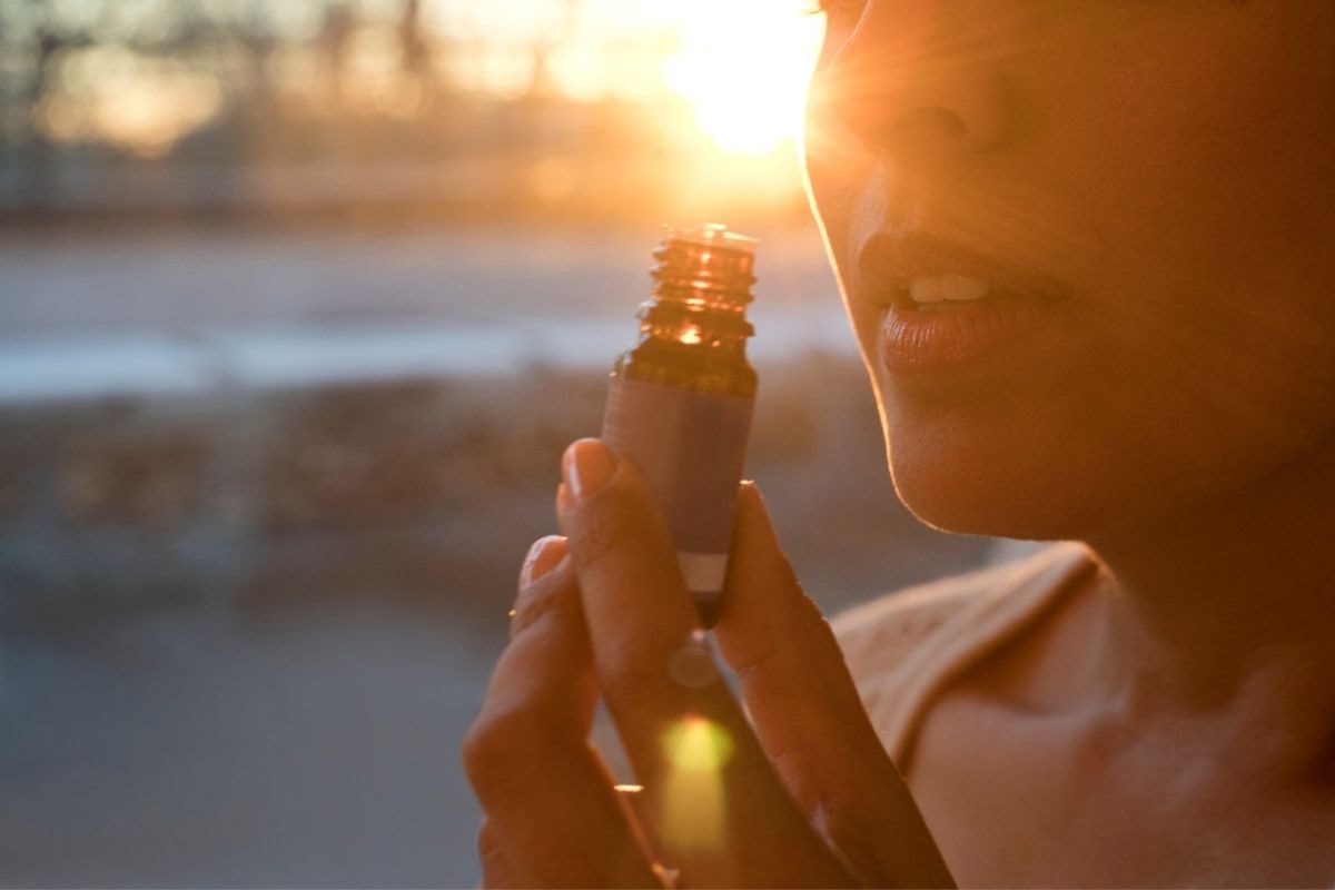 A woman inhaling essential oils for sinus infection.