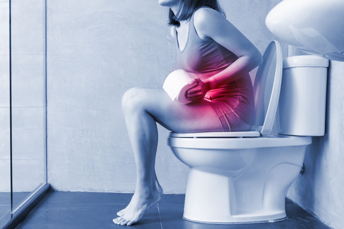 a woman on constipation sitting on a bowl, trying to poop