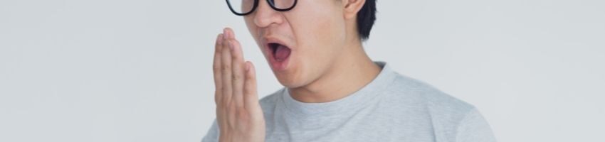 A man suffering from bad breath as a result of mouth bacteria.