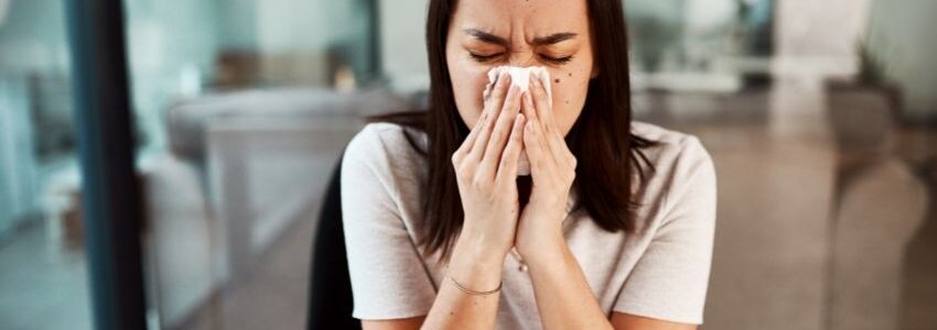 A woman having a hard time breathing through her nose.