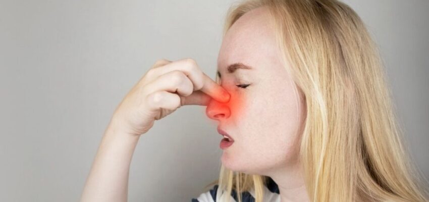 A woman suffering from a stuffy nose who is looking for a natural decongestant.