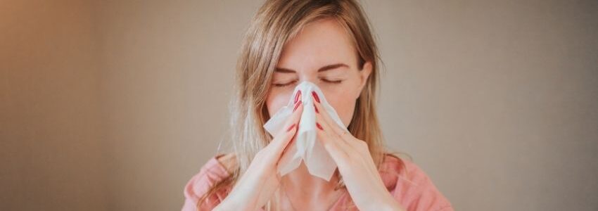 A woman suffering from stuffed nose.