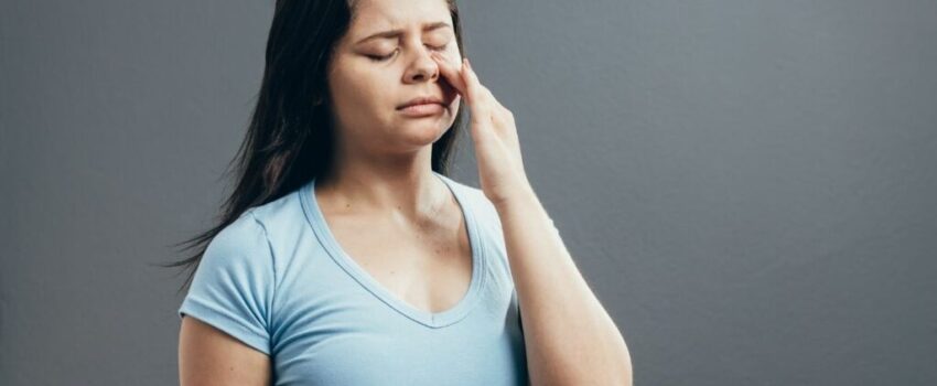 A woman smiling after her mouth sore was treated.