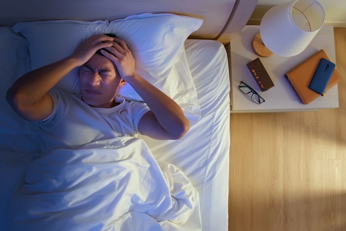 A man experiencing sinus headache at night.