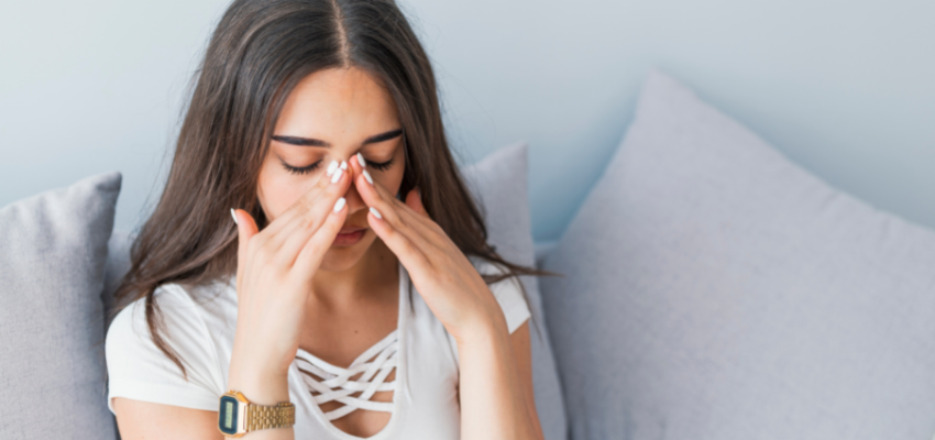 A woman suffering from a sinus infection.