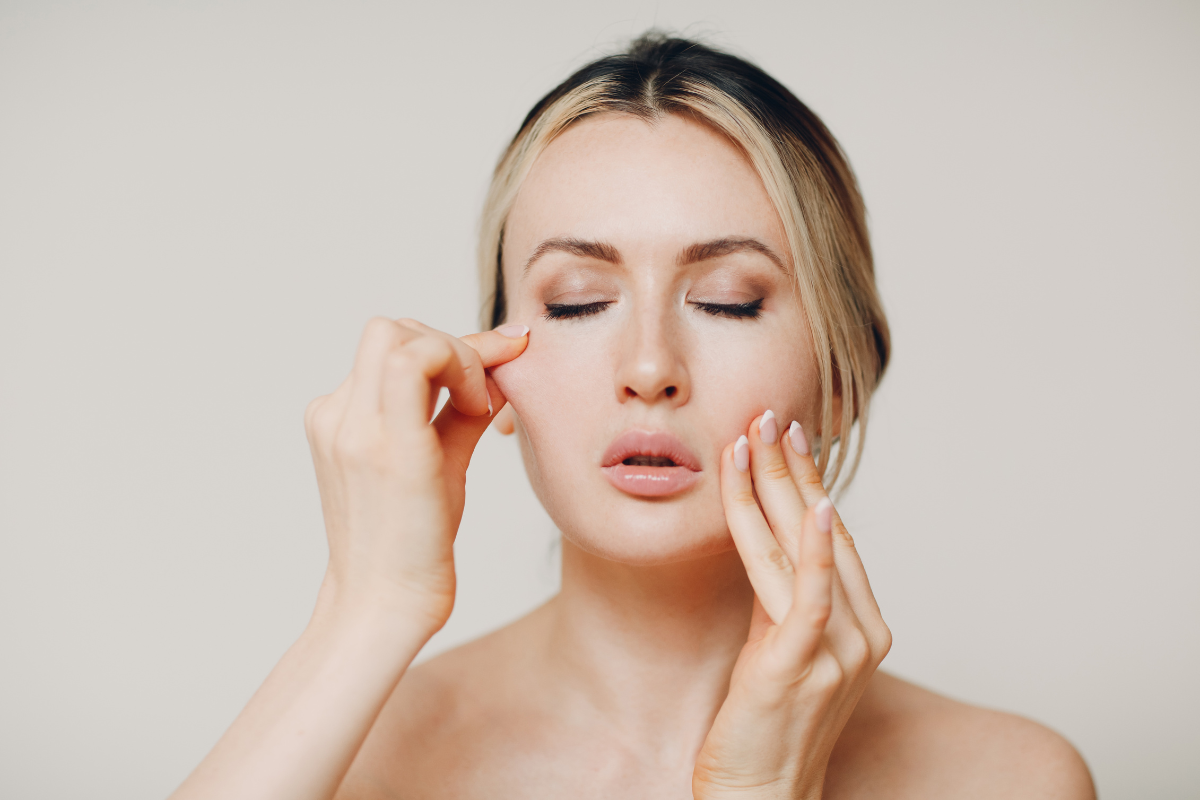 A woman getting a facial massage.