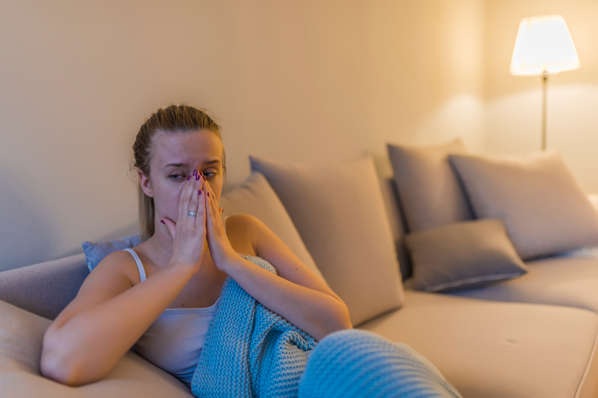 A woman massages her sinuses to drain the maxillary sinus.