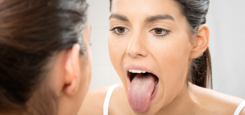 A woman checks if she has a healthy tongue.