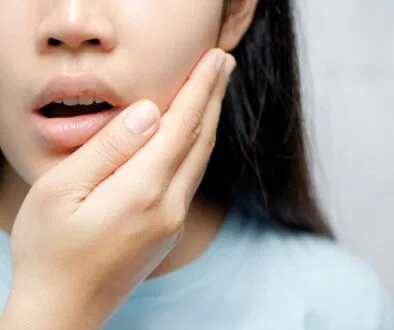 The woman feels discomfort due to oral thrush.