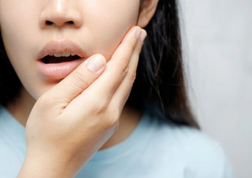 The woman feels discomfort due to oral thrush.