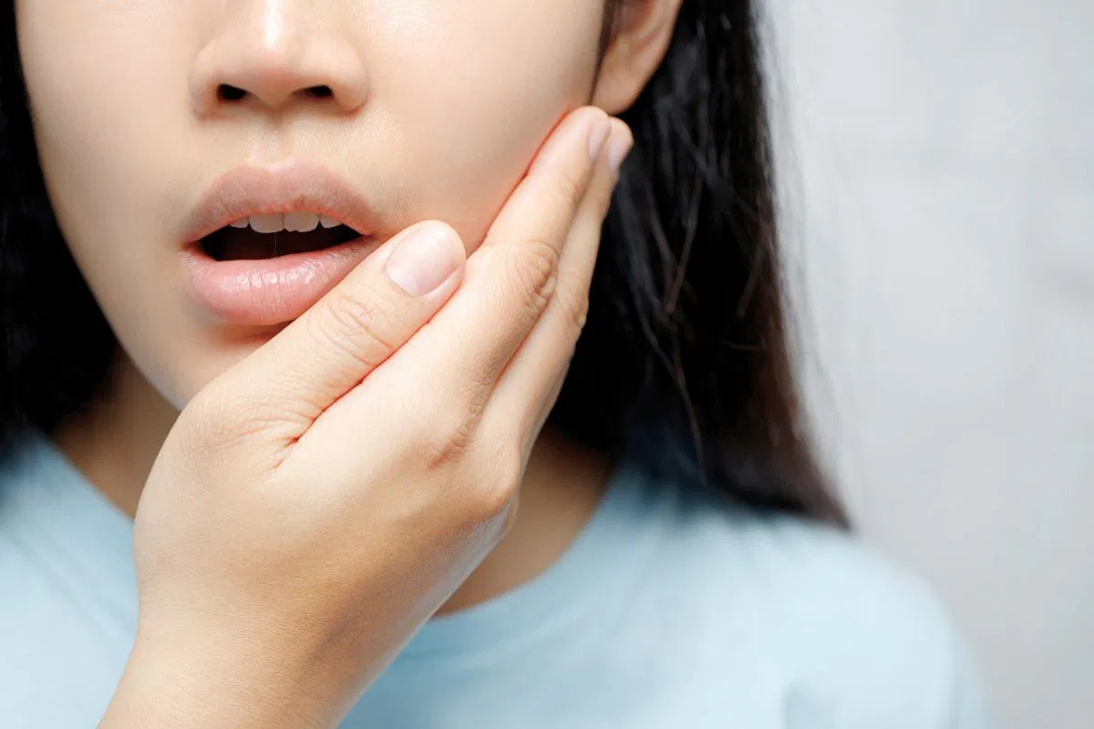 The woman feels discomfort due to oral thrush.
