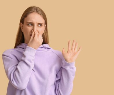 Woman reacting to unpleasant odor with tips on how to stop protein farts