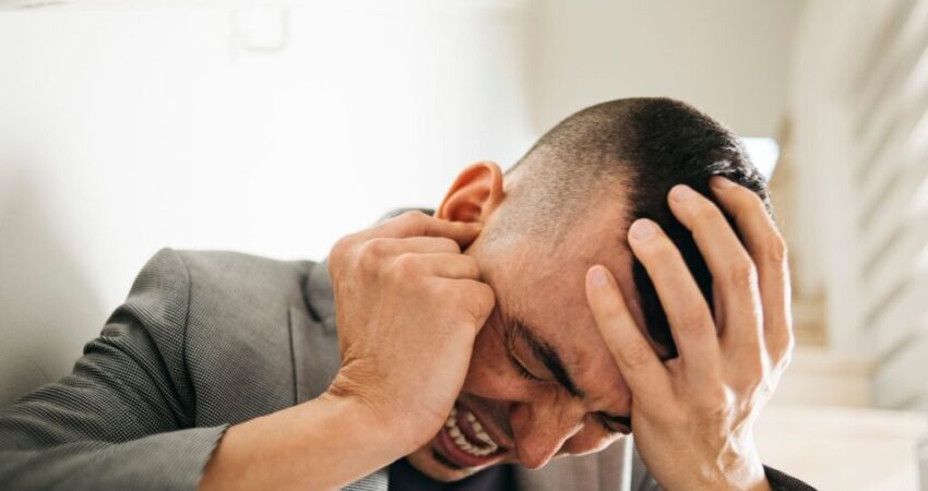 A man suffers from earache and headache at the same time.