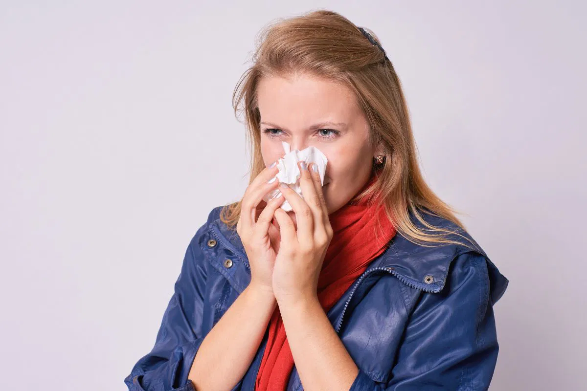 The woman is experiencing post-nasal drip.