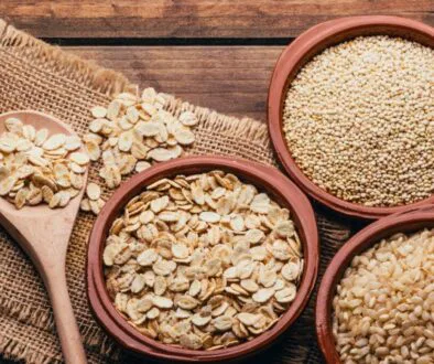The wooden bowls have oats and quinoa.