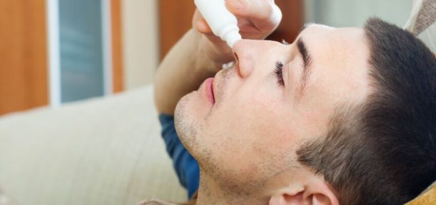 A woman suffering from post-nasal drip caused by allergens.