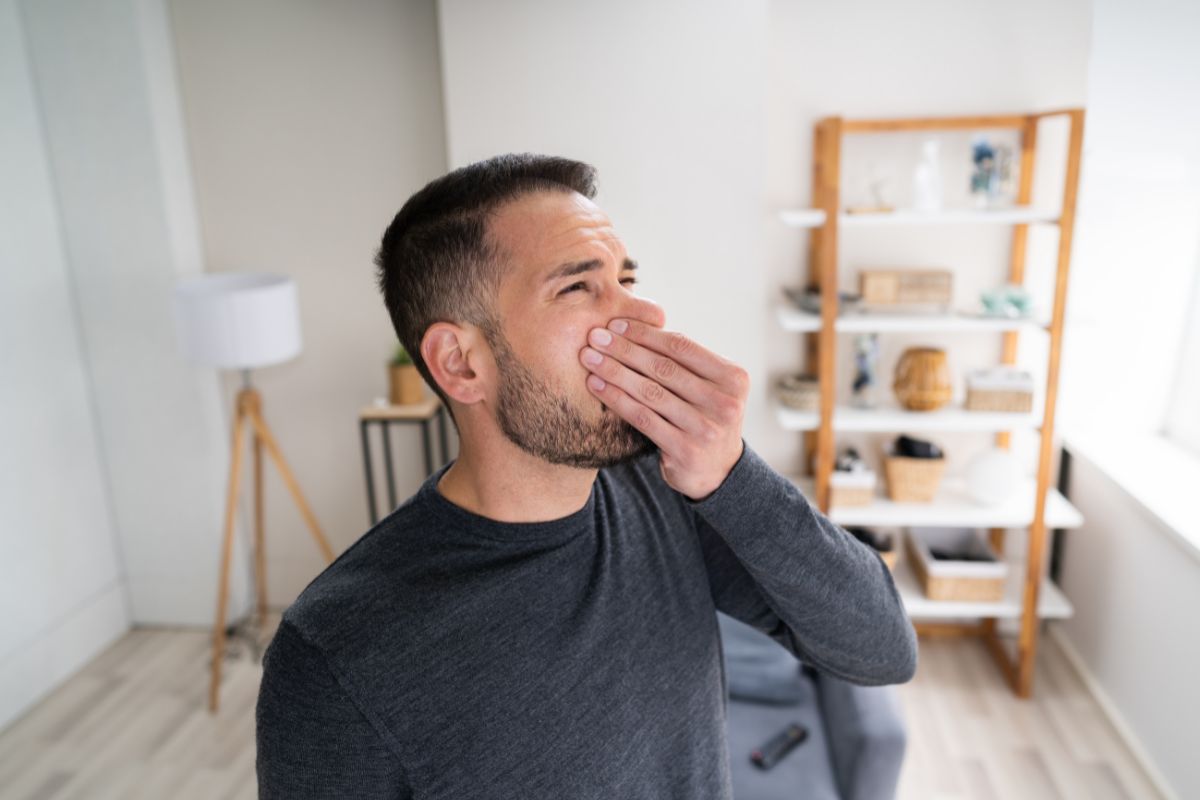 The man notice his bad smell in nose.