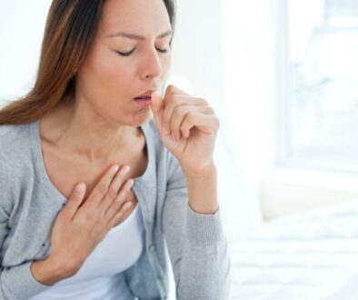 The woman is coughing.