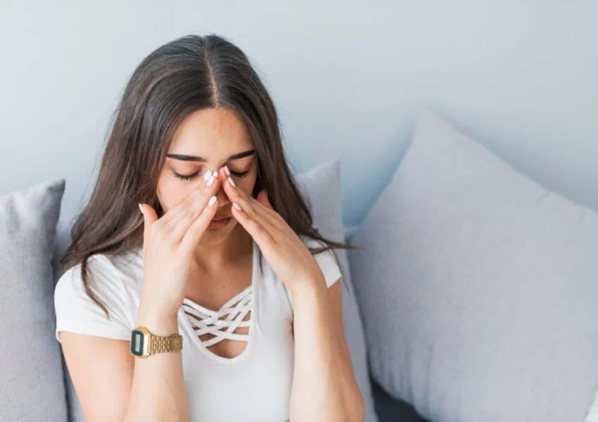 A woman is struggling with a sinus infection.