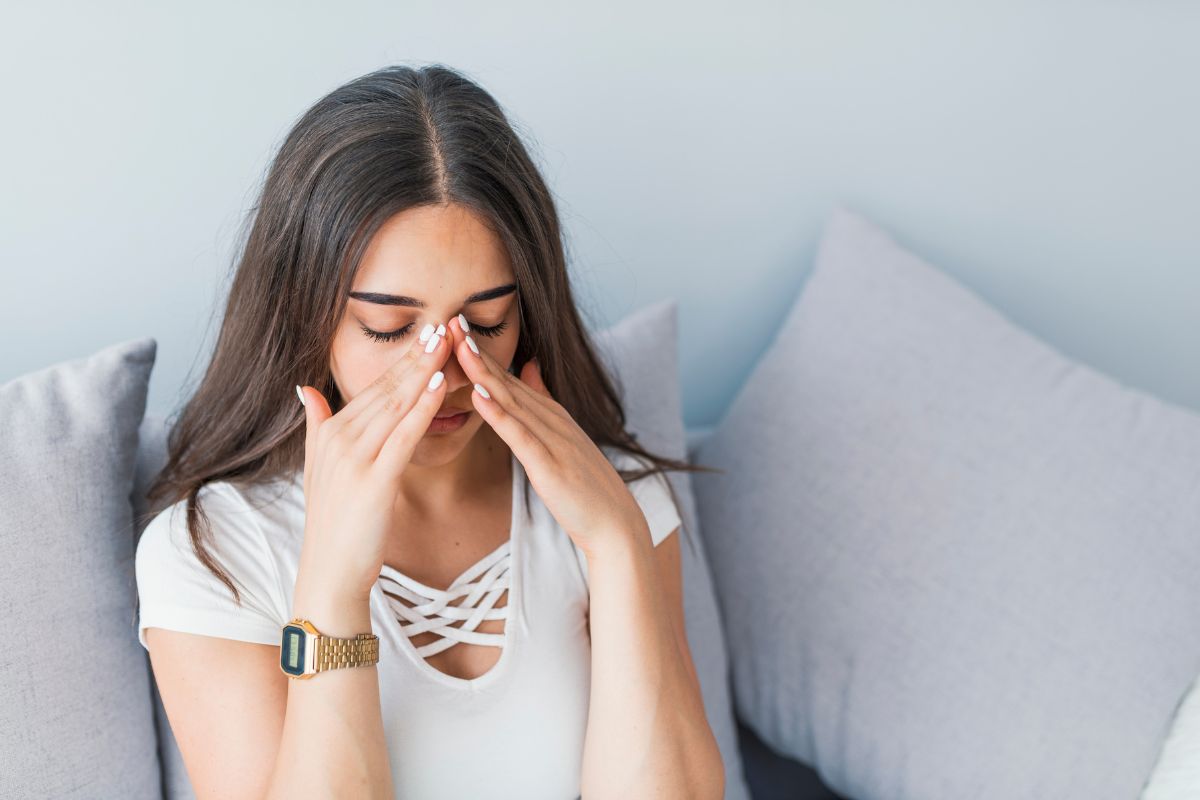 A woman is struggling with a sinus infection.