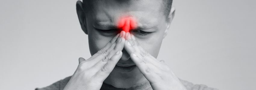 A man is struggling with a sinus infection.