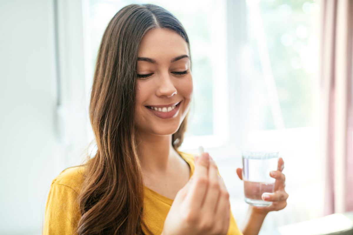 A woman is taking probiotics on an empty stomach.