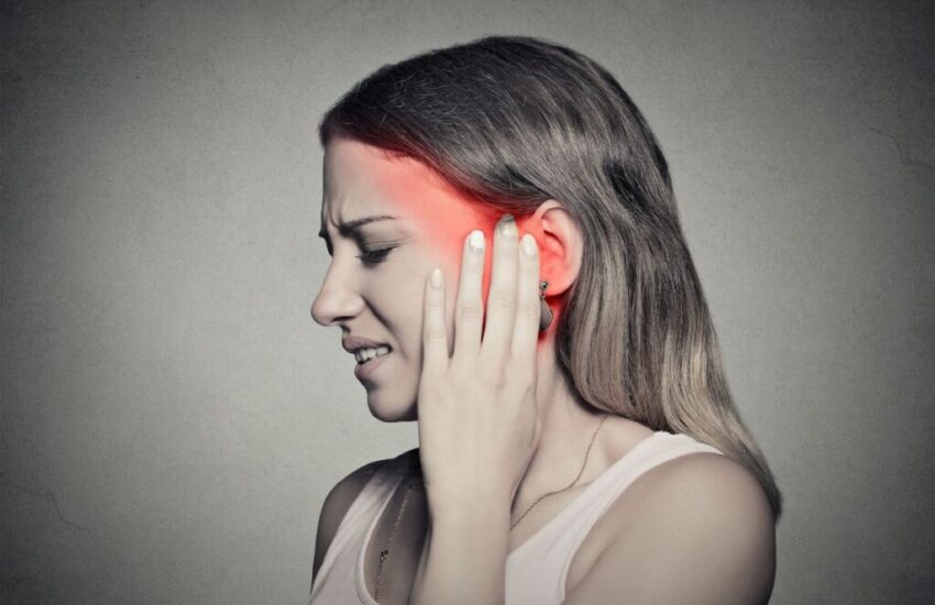 The woman feels pain due to ear congestion.