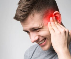 The man feels discomfort due to ear congestion.