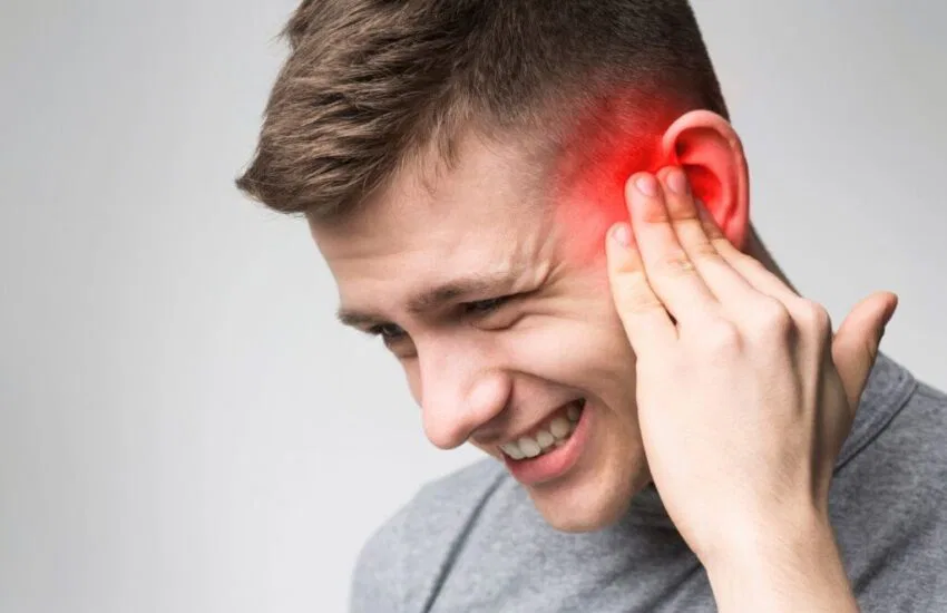 The man feels discomfort due to ear congestion.