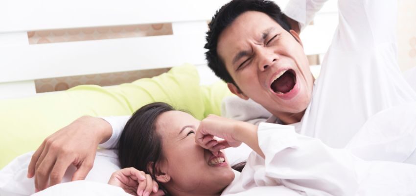 The wife is annoyed because her husband's breath stinks in the morning.