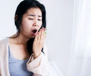 The woman is curious why her breath stinks in the morning.